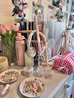 a table topped with plates and vases filled with flowers