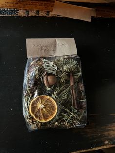 a bag filled with dried herbs and an orange