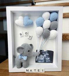 an elephant and its baby are in a shadow box with the word boy written on it