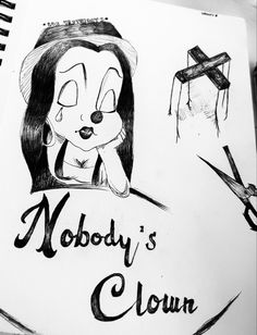 a drawing of nobody's clown sitting next to a crucifix with the words nobody's clown written on it