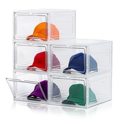 four clear bins with hats in them on a white background and one is empty