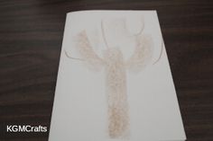 a white paper with an image of a deer on it sitting on a wooden table