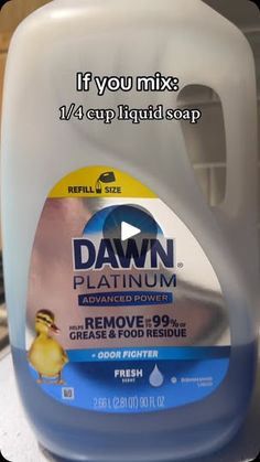 a gallon of dawn dish soap sitting on top of a counter next to a yellow rubber duck