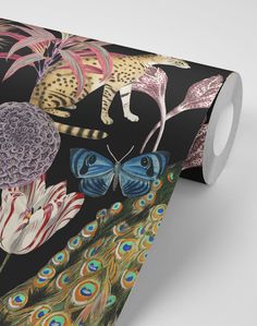 a black wallpaper with colorful florals and peacocks on it, next to a white toilet paper roll