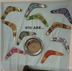 a bulletin board with various signs on it and a dog bowl in front of it