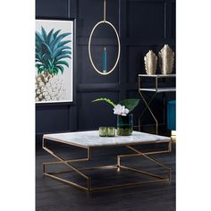 a living room with black walls, gold accents and a marble coffee table in the middle