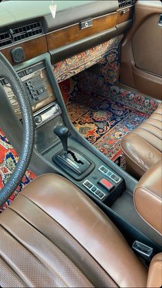 the interior of a car with leather seats and dashboard controls, including an automatic steering wheel