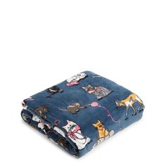 a blue blanket with cats and mice on it, sitting on top of a white surface