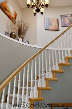 a chandelier hanging from the ceiling next to a stair case in a home