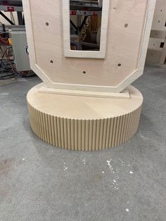 a large wooden object sitting on top of a cement floor