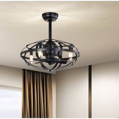 a black chandelier hanging from the ceiling in a room with curtains and drapes