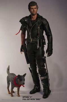 a man in black leather outfit standing next to a small dog on a white background