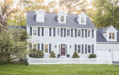 a large white house with black shutters