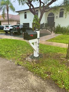 a mailbox in front of a white house