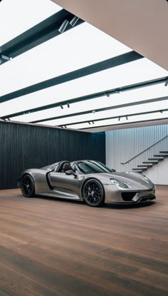 a silver sports car parked in an empty garage