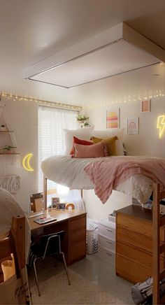 a bedroom with a loft bed, desk and computer on the other side of the room