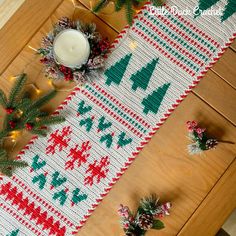 a knitted table runner with candles and christmas decorations