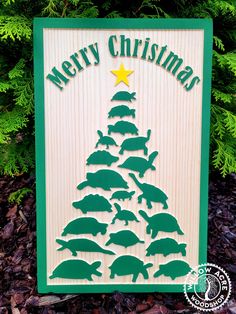 a christmas tree made out of wood with animals on it and the words merry christmas