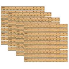 wooden rulers are lined up in rows on a white background, each with different sizes and shapes