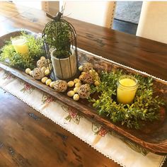 a tray with plants and candles on it