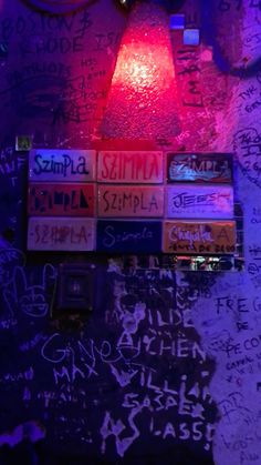 the wall is covered in graffiti and lights