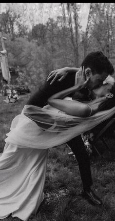 black and white photograph of a man kissing a woman