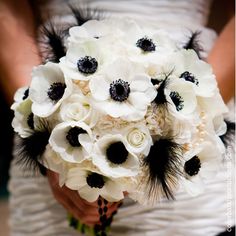 a bridal bouquet with white and black flowers