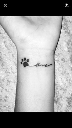 a dog paw with the word love written on it's wrist and an animal track