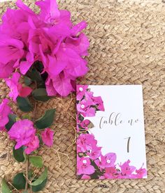 pink flowers are sitting on the table next to a card that says table up 1