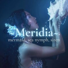 a beautiful woman in a dress holding a shell under water with the words merdia on it