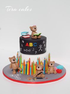 there is a cake that has bears on it and books in the middle with letters