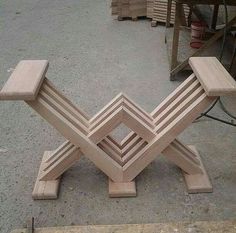 a wooden bench sitting on top of a cement floor