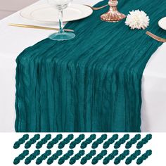 the table is set with green linens and place settings for two people to sit at