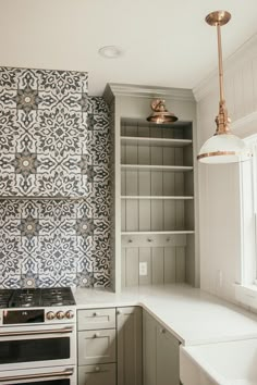 a kitchen with an oven, sink and cupboards in the backround area