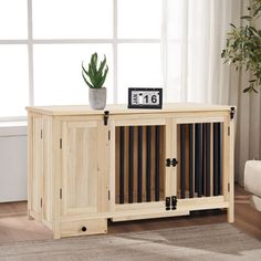 a living room with a couch and a wooden cabinet in it that has a clock on top