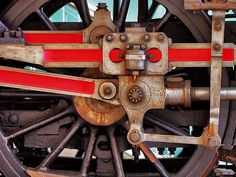 the wheels and spokes of an old train