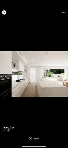 an image of a kitchen with white cabinets and wood flooring in the middle of it