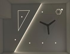 a clock that is on the side of a wall in a room with lights around it