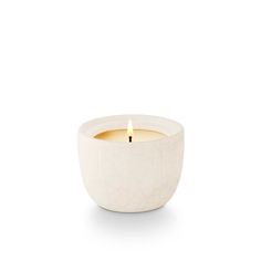 a white candle that is sitting in front of a white background