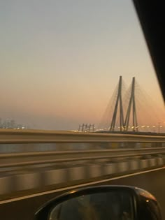 the view from inside a car looking at a bridge