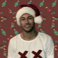 a man wearing a santa hat and smiling at the camera