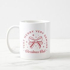 a white coffee mug with a red ribbon and merry christmas club logo on the front