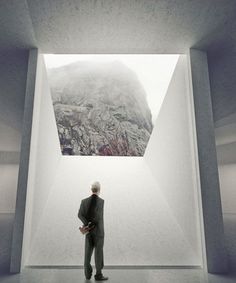 a man standing in an empty room looking up at the sky with a mountain view