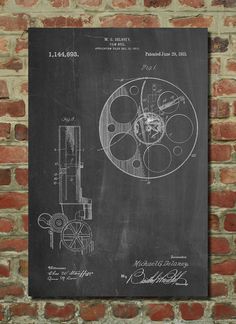 a blackboard with a drawing of a wheel on it next to a brick wall