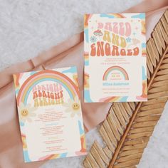 wedding stationery with rainbow theme and palm fronds on the floor next to it