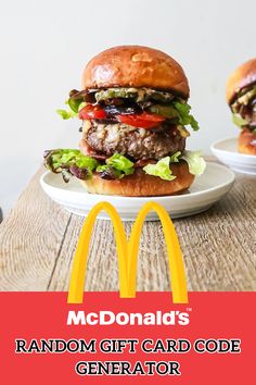 two hamburgers sitting on top of a white plate next to a mcdonald's logo