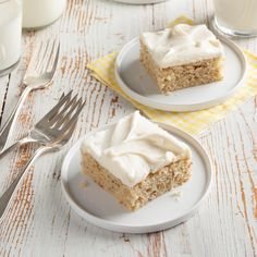 two pieces of cake sitting on top of plates next to a fork and glass of milk