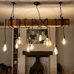 a bunch of lights hanging from a wooden beam