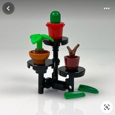 there are three small potted plants on the same stand, each with different colors