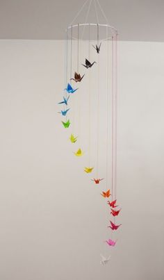 a wind chime with colorful origami birds hanging from it